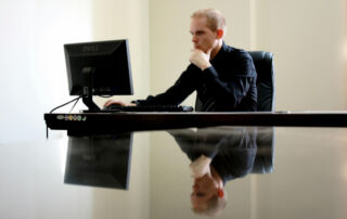 Man sitting at a computer looking at the screen
